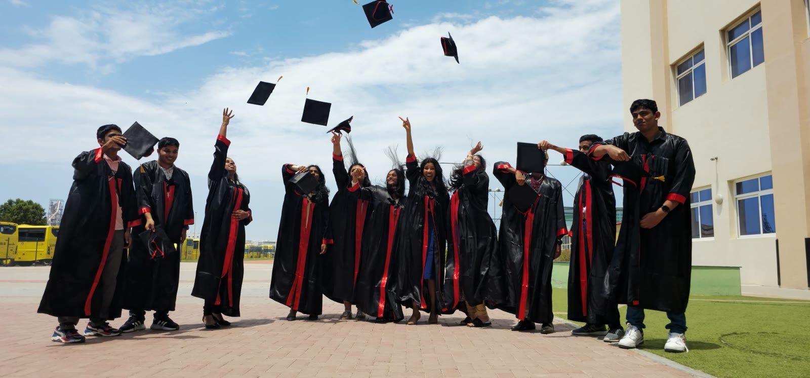 Sunday School graduates throwing their caps in the air